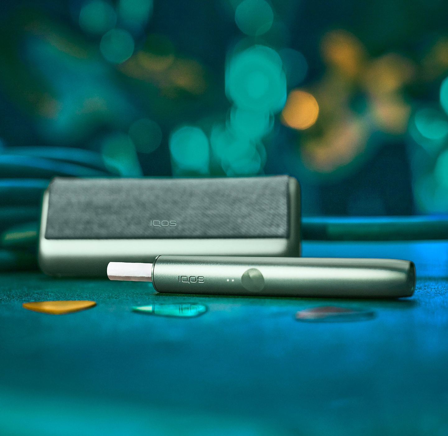 A Jade Green IQOS ILUMA PRIME Holder and Pocket Charger.